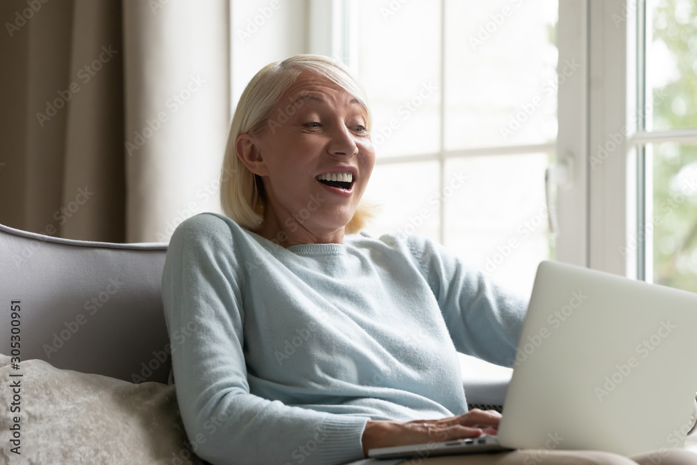 Woman looking at computer screen feels shocked received unbelievable offer Woman looking at computer screen feels shocked received unbelievable offer
