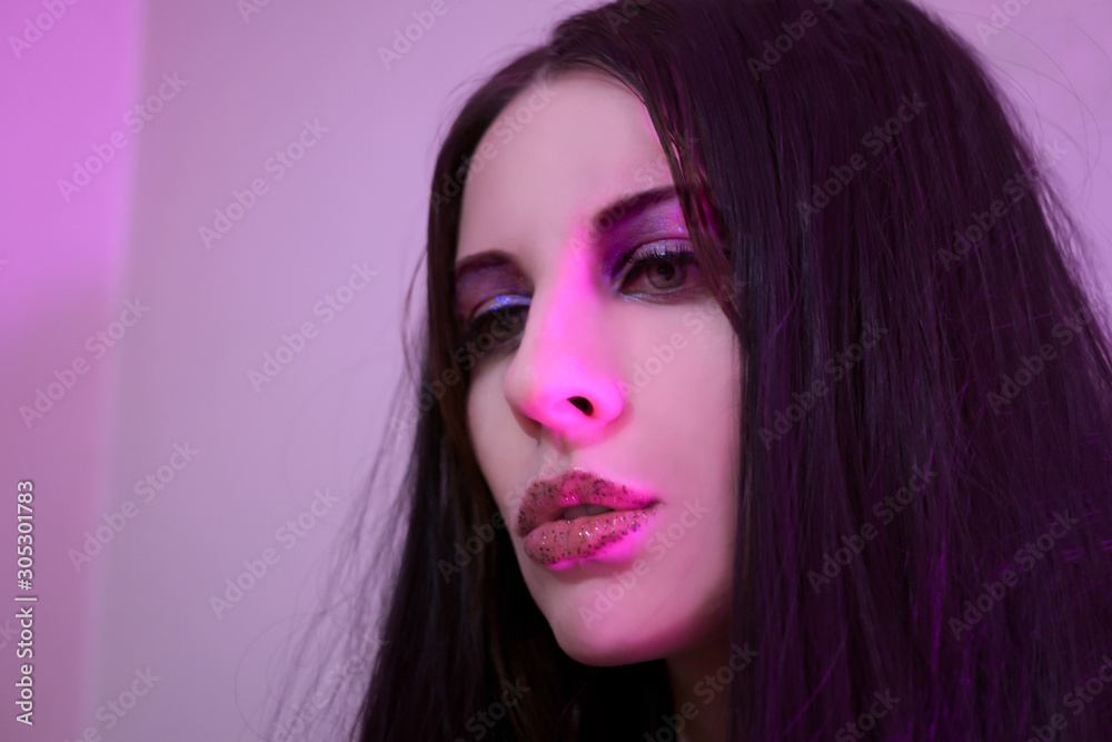Portrait of young woman in pink neon light Portrait of young woman in pink neon light