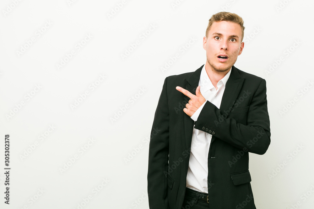 Young caucasian business man pointing to the side Young caucasian business man pointing to the side