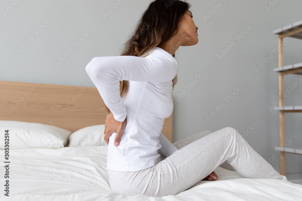 Woman while awake feels painful feelings in lower back Woman while awake feels painful feelings in lower back