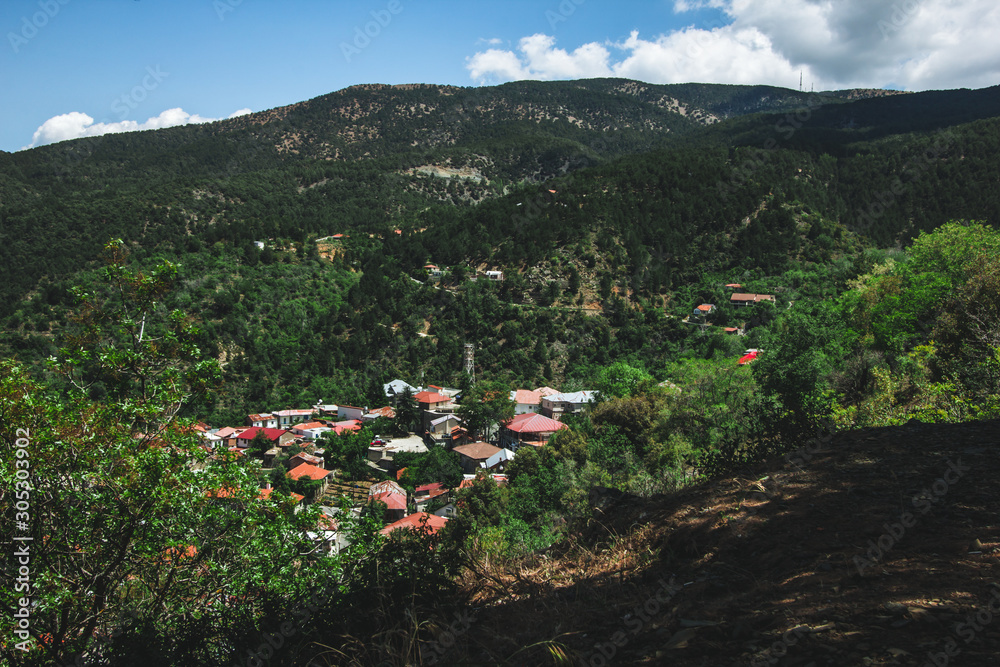 Orange roofs. Panoramic view near of Kato Lefkara - is the most famous village in the Troodos Mountains. Limassol district, Cyprus, Mediterranean Sea. Mountain landscape and sunny day.