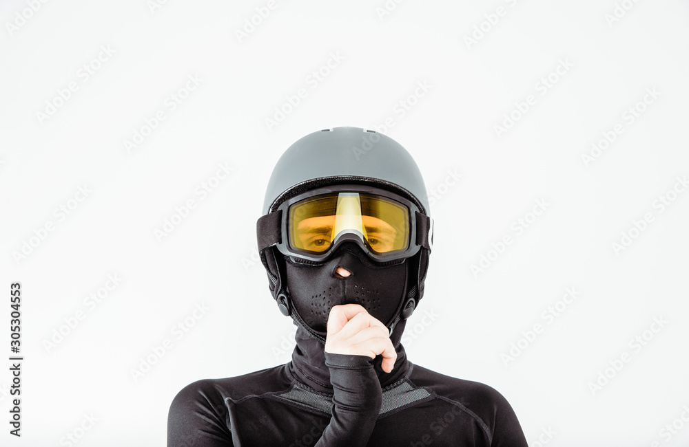 An athlete wearing a sweatshirt and helmet prepares for sport. The concept of playing sports, extreme sport. Putting on the necessary protective clothing.