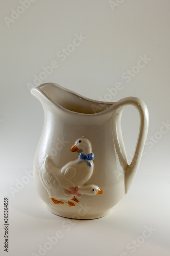 White pitcher with ducks on the front 