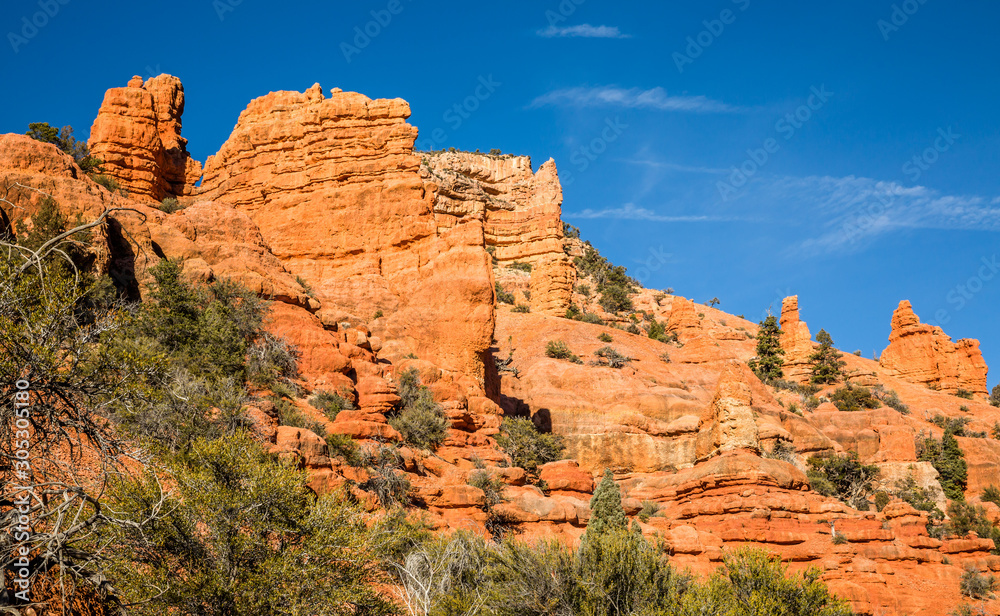Towering cliffs of red sandstone in Southern Utah desert near Bryce Canyon National Park.