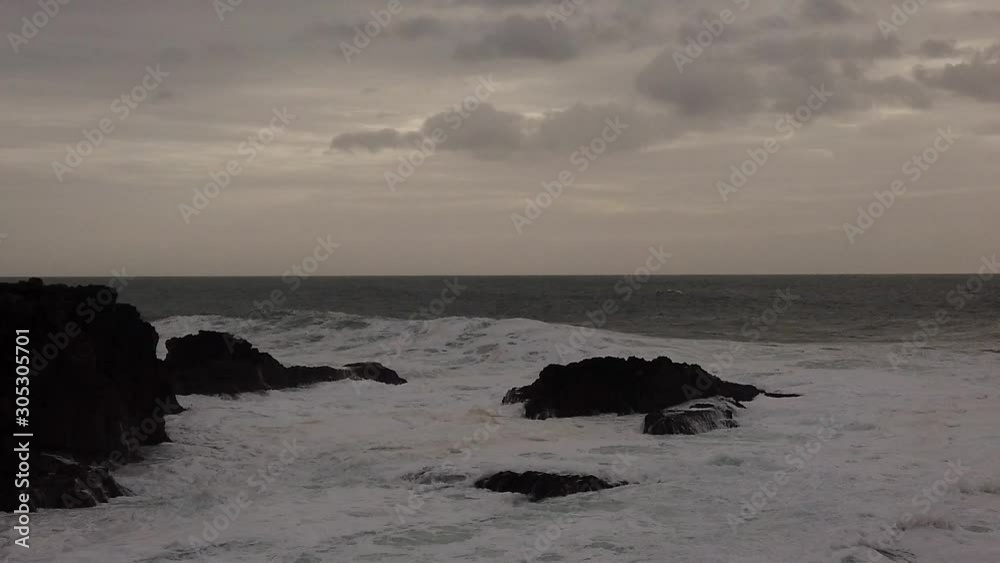 Slow motion of a ocean wave splashes in a big rock. Slow motion of a ocean wave splashes in a big rock.