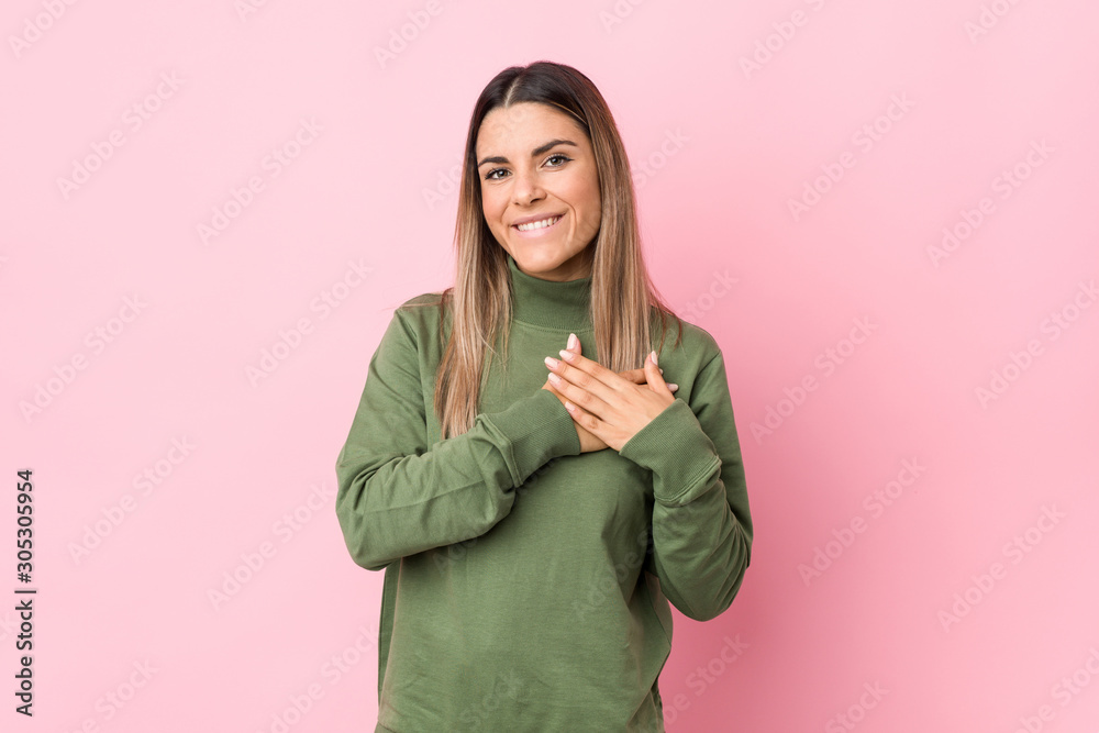 Young caucasian woman isolated has friendly expression, pressing palm to chest. Love concept. Young caucasian woman isolated has friendly expression, pressing palm to chest. Love concept.