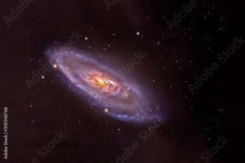 A beautiful blue galaxy with an orange core. Elements of this image furnished by NASA © Artsiom P