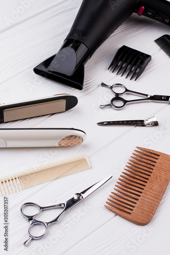 Hairdresser tools on wooden background. Set of hairdresser tools and accessories.