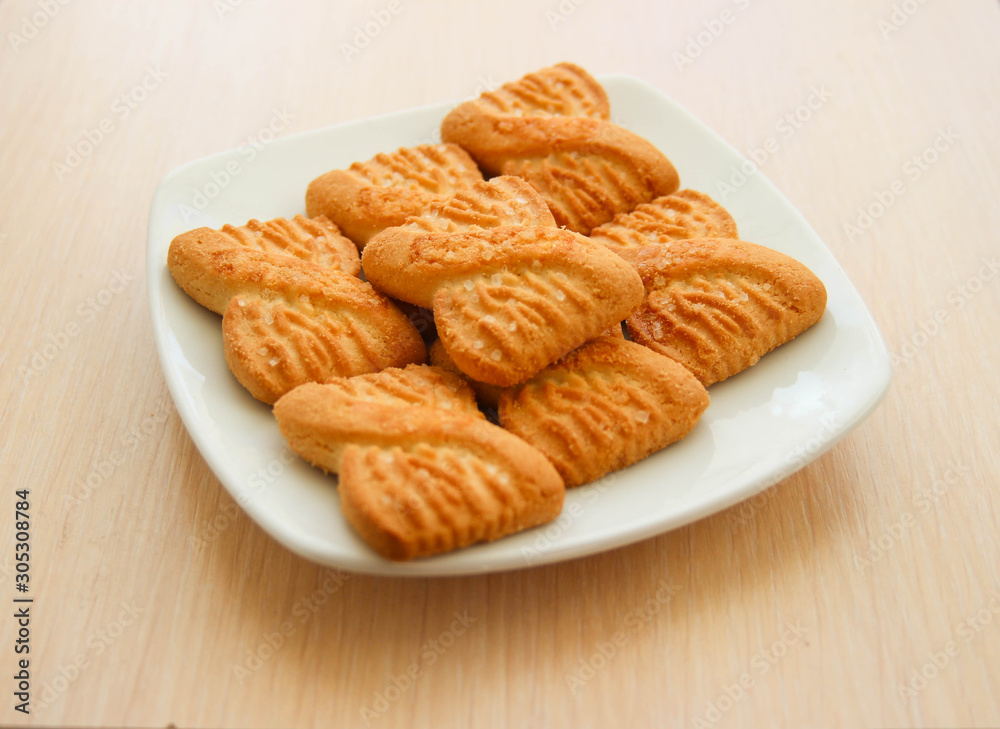 The photo of a pile of cookies or shortcake biscuits on the plate. National Cookie Day background The photo of a pile of cookies or shortcake biscuits on the plate. National Cookie Day background