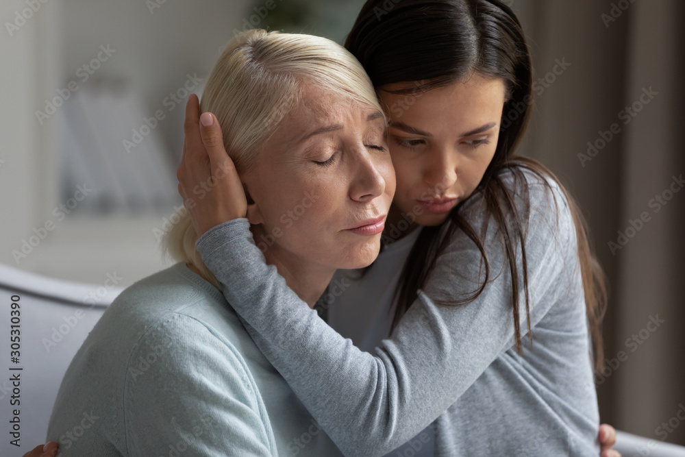 Fototapeta premium Mom share problems adult daughter hugs soothes her showing compassion