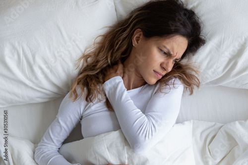 Above view frown woman feels pain in neck