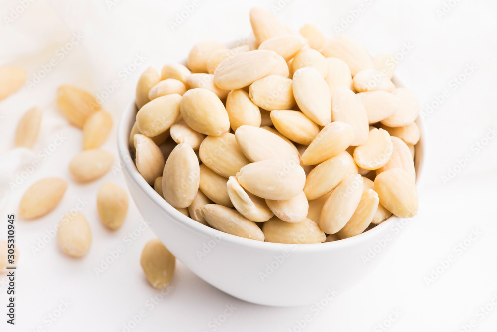 Bowl of almonds on a white background Bowl of almonds on a white background