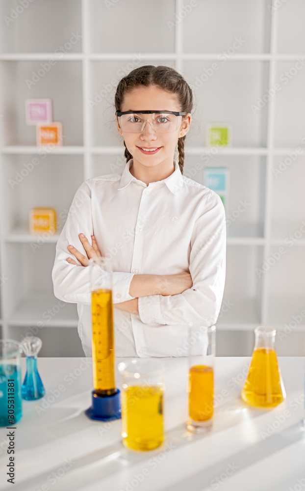 Confident little chemist standing in laboratory Confident little chemist standing in laboratory