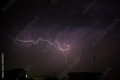 Thunderbolt over the city during a storm at night
