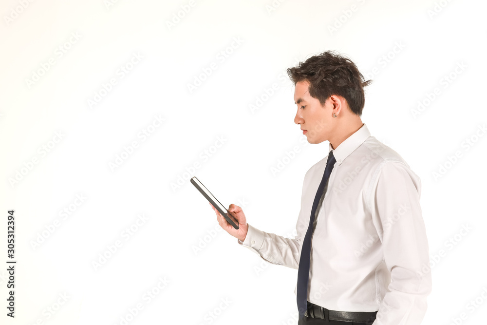 Portrait of smart young asian businessman wearing white shirt holding and looking to computer tablet on isolated white background and copy space. Portrait of smart young asian businessman wearing white shirt holding and looking to computer tablet on isolated white background and copy space.