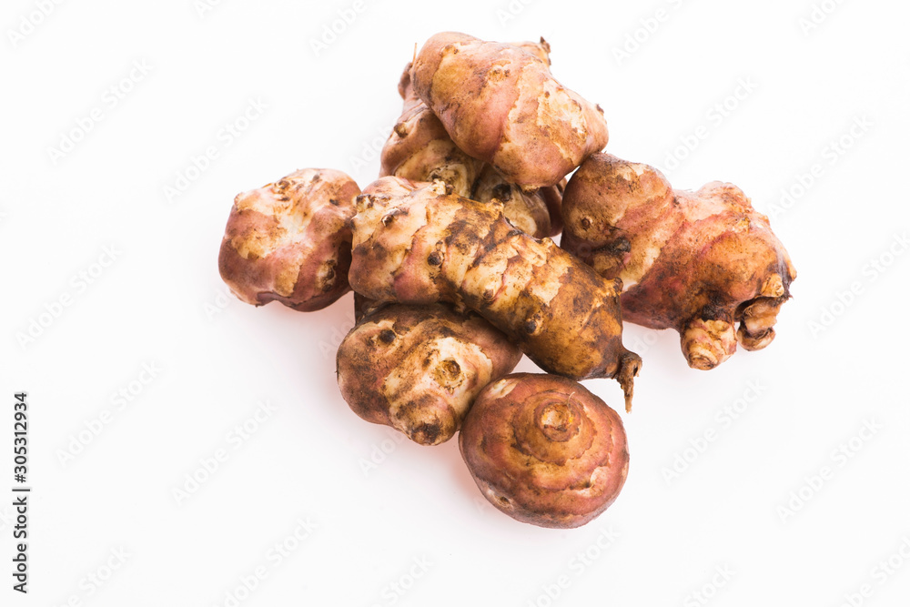 Raw Whole ans sliced Jerusalem artichokes on a white background Raw Whole ans sliced Jerusalem artichokes on a white background