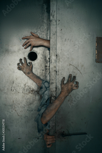 Zombie hands sticking out of the elevator door