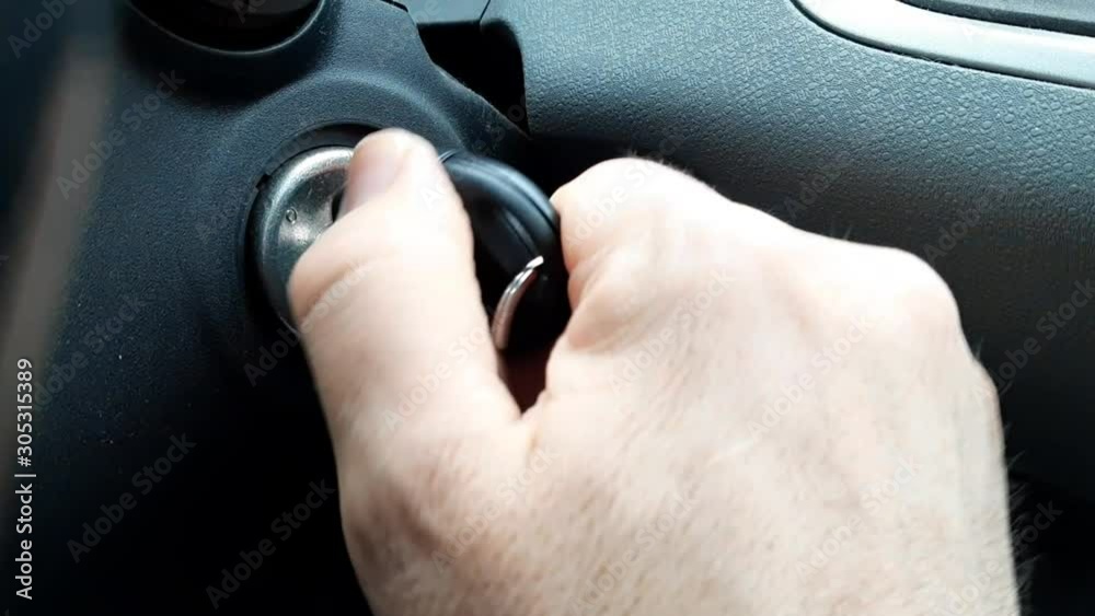 Starting the engine of a car the key is inserted into the dashboard