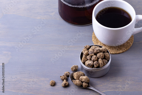 black sugar, kuro sato, in a metal tin served along with tea.