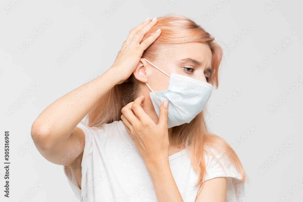 Close up studio portrait of woman in white t-shirt with medical mask who scratching itchy throat. Irritation, sensitive dry skin, allergy symptoms, dermatitis, insect bites. Healthcare concept. Close up studio portrait of woman in white t-shirt with medical mask who scratching itchy throat. Irritation, sensitive dry skin, allergy symptoms, dermatitis, insect bites. Healthcare concept.