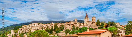 Panoramic view of Spello medieval hisitoric center in Umbria countryside with clouds above