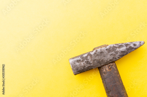 Old Hammer Isolated on a yellow background. from above. Copy space