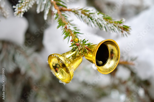 фотографія Snow covered branches of the Christmas tree decorated with toys.