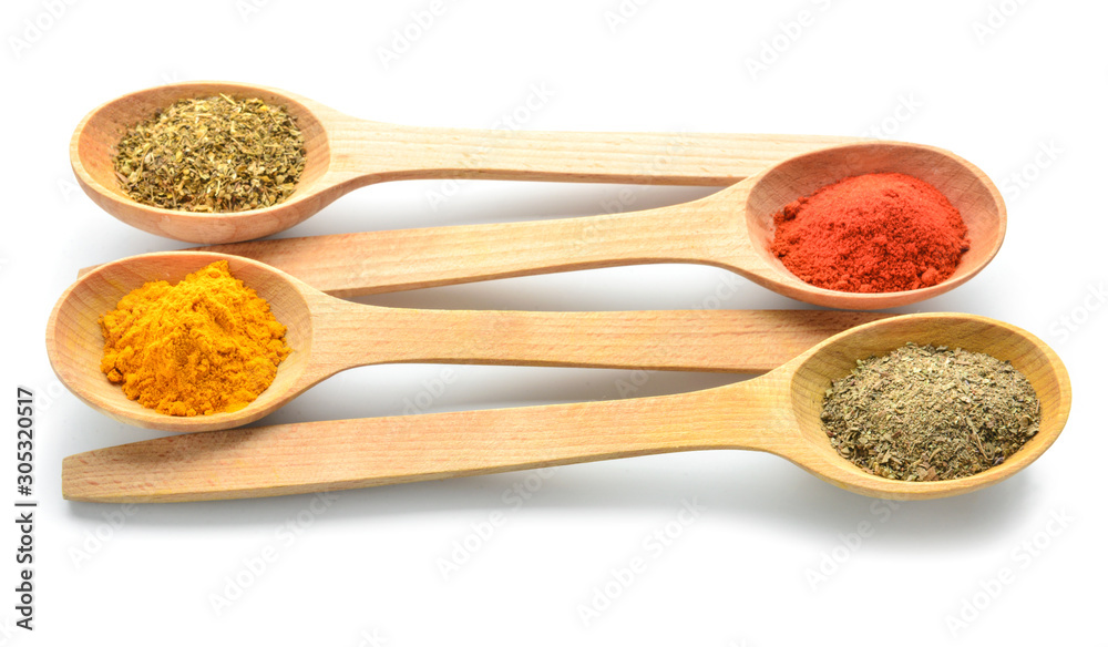 Spoons with different spices on white background Spoons with different spices on white background