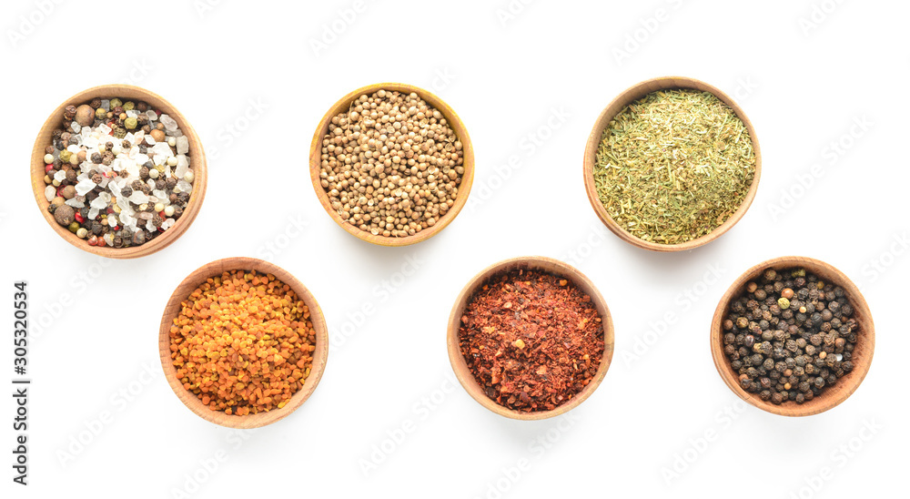 Bowls with different spices on white background Bowls with different spices on white background