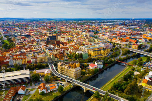 Fototapeta Naklejka Na Ścianę i Meble -  Picturesque aerial view of old buildings of Pilsen cityscape with river and ponds, Czech Republic