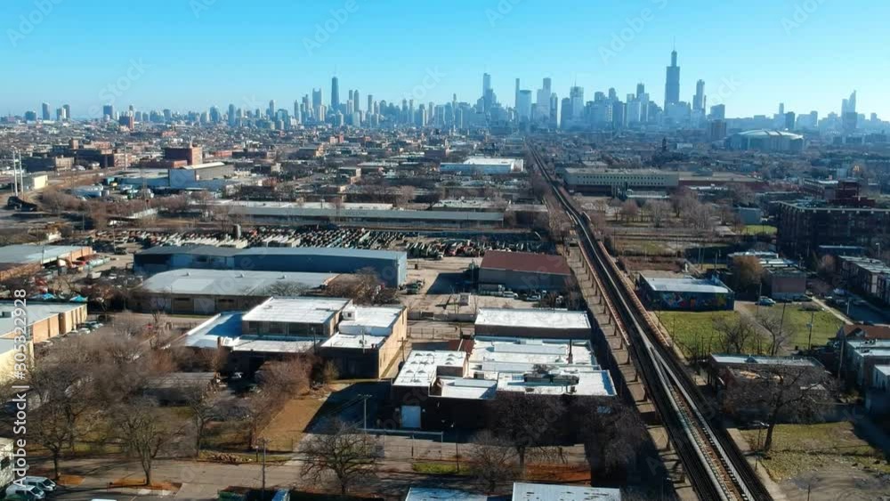 aerial drone landscape view of a urban neighborhood on the west side of Chicago during afternoon. skyscraper of tall buildings can be seen in the background. while the small communities are quite. aerial drone landscape view of a urban neighborhood on the west side of Chicago during afternoon. skyscraper of tall buildings can be seen in the background. while the small communities are quite.