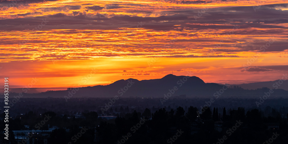 Los Angeles panoramic dawn with colorful fall clouds.  San Fernando Valley view towards Griffith Park and the Santa Monica Mountains from the Santa Susana Pass in Chatworth, California. 