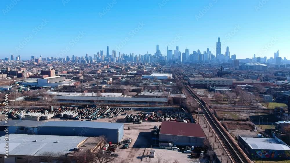 aerial drone landscape view of a urban neighborhood on the west side of Chicago during afternoon. skyscraper of tall buildings can be seen in the background. while the small communities are quite. aerial drone landscape view of a urban neighborhood on the west side of Chicago during afternoon. skyscraper of tall buildings can be seen in the background. while the small communities are quite.