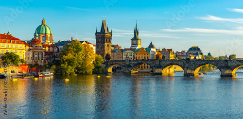 View of Prague, Charles bridge and the Vltava river with tourist boats floating