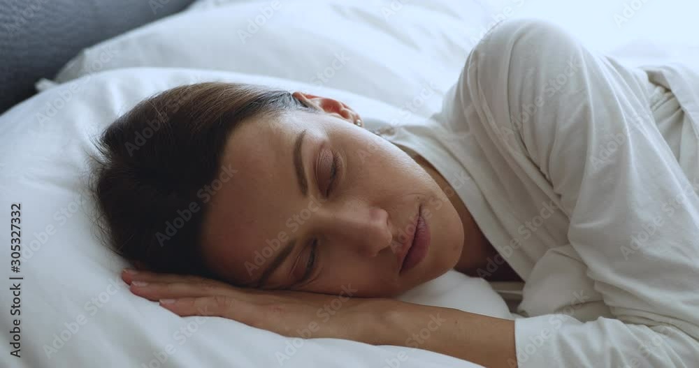 Scared shocked awoken young lady lying in bed alone Scared shocked awoken young lady lying in bed alone