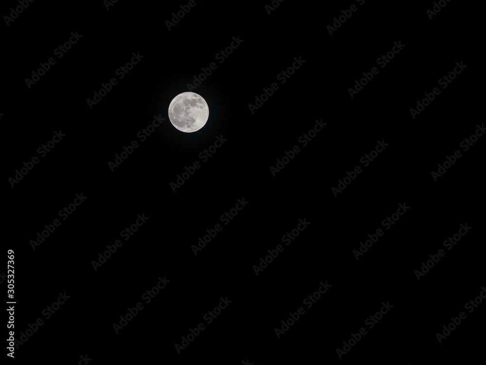December full moon against pitch black sky December full moon against pitch black sky