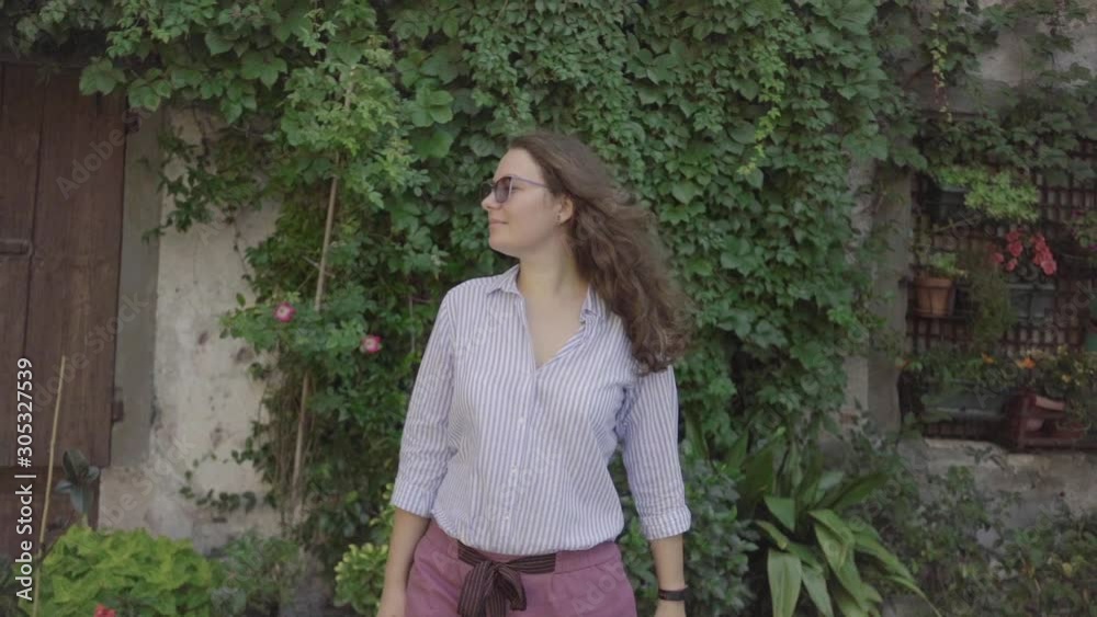 Beautiful woman walking in small Italian city. Girl walking and looking around. Slow motion video Happy model in good mood at vacation Beautiful woman walking in small Italian city. Girl walking and looking around. Slow motion video Happy model in good mood at vacation