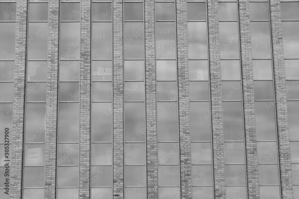Red brick buildings and long windows as a background. Black and white