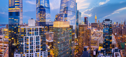 Aerial panorama of New York City skyscrapers at dusk as seen from above the 29th street, close to Hudson Yards and Chelsea neighborhood © mandritoiu