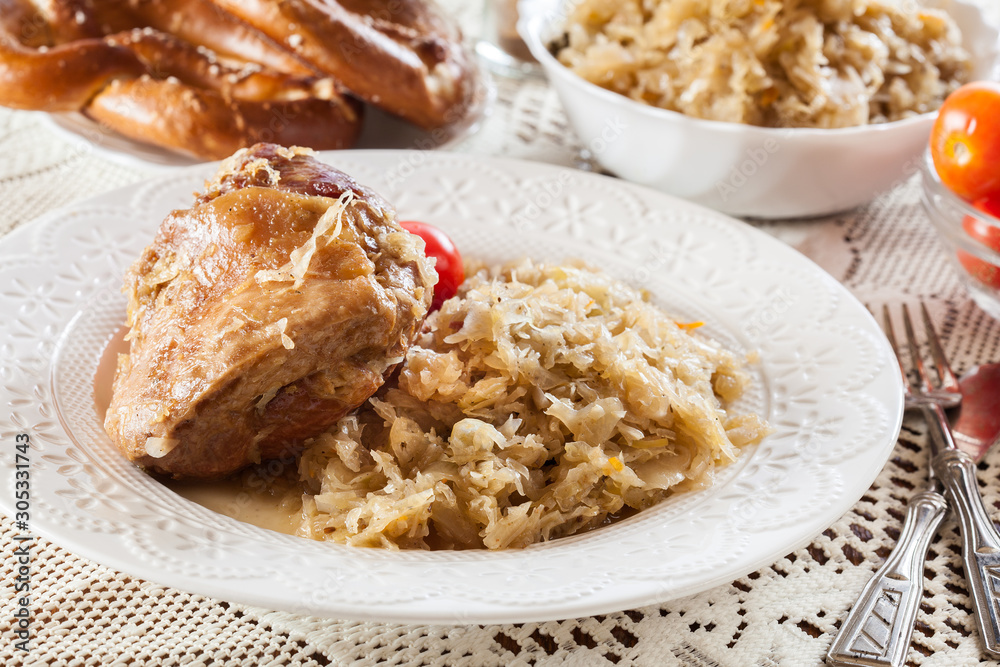 Pork knuckle with fried sauerkraut and tomatoes Pork knuckle with fried sauerkraut and tomatoes