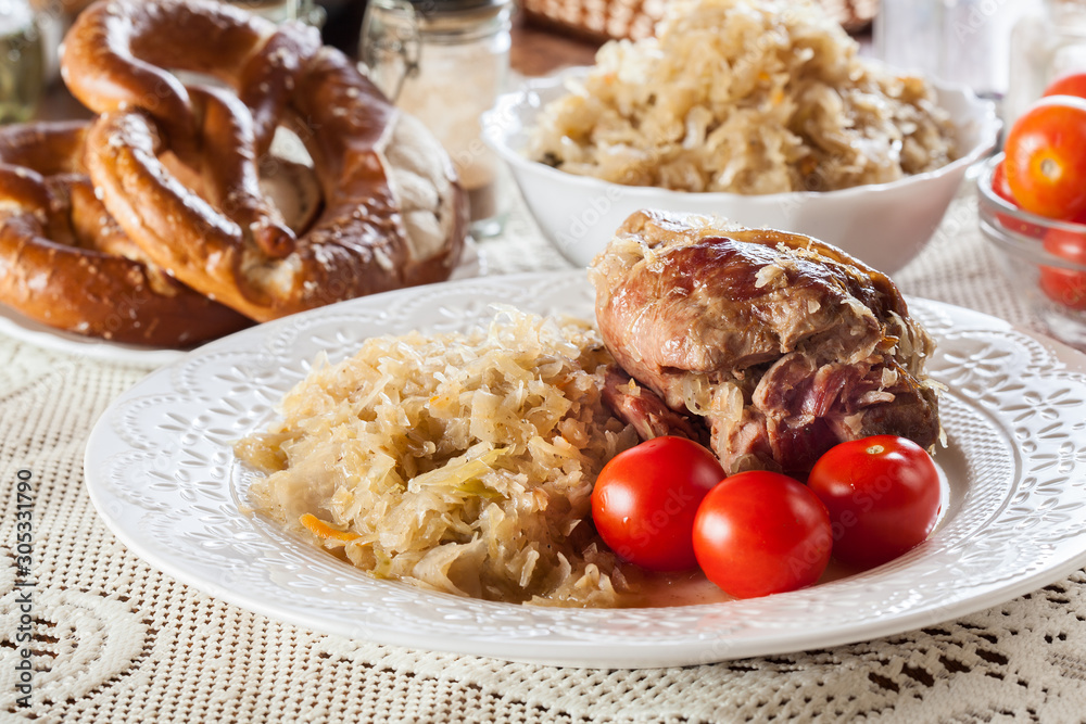 Pork knuckle with fried sauerkraut and tomatoes Pork knuckle with fried sauerkraut and tomatoes