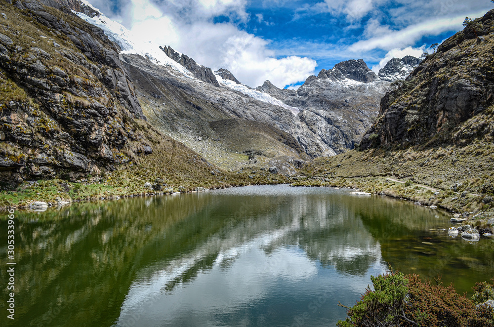 Mountains reflections on a glacial lake in the Cordillera, Blanca. Huaraz, Peru