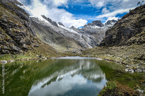 Fototapeta Naklejka Na Ścianę i Meble -  Mountains reflections on a glacial lake in the Cordillera, Blanca. Huaraz, Peru