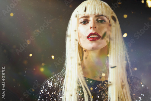 Portrait of a beautiful platinum blonde female model isolated on black studio background
