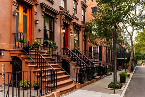 Brownstone facades & row houses at sunset in an iconic neighborhood of Brooklyn Heights in New York City