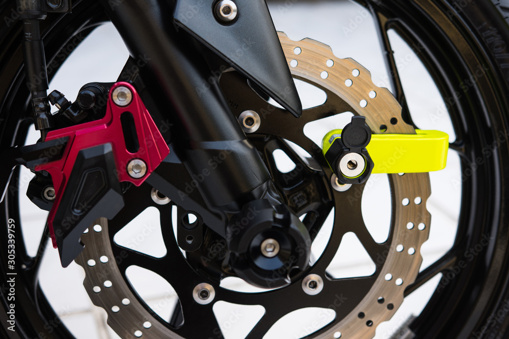 Obraz premium Close Up of Yellow Disc Lock on Motorcycle Disc Brake