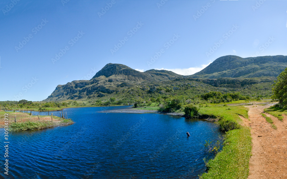 Lake, mountains and blue sky in Lapinha da Serra, Brazil.