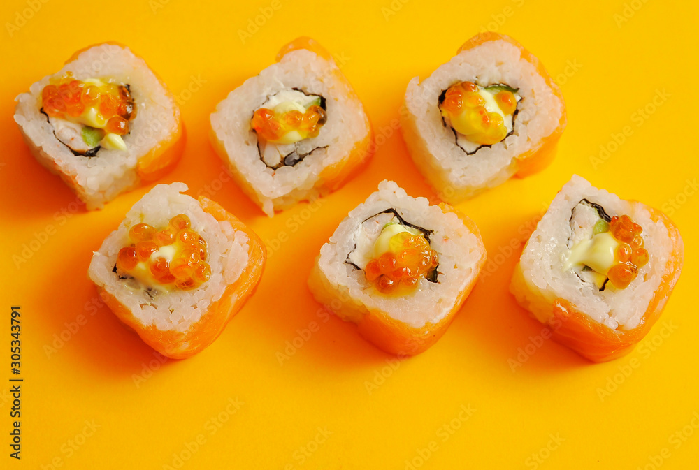 Japanese rolls on yellow background.