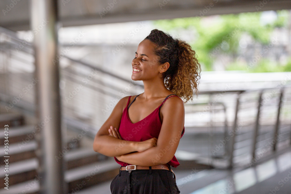 Portrait of young beautiful business woman at outside. Crossed arms Portrait of young beautiful business woman at outside. Crossed arms