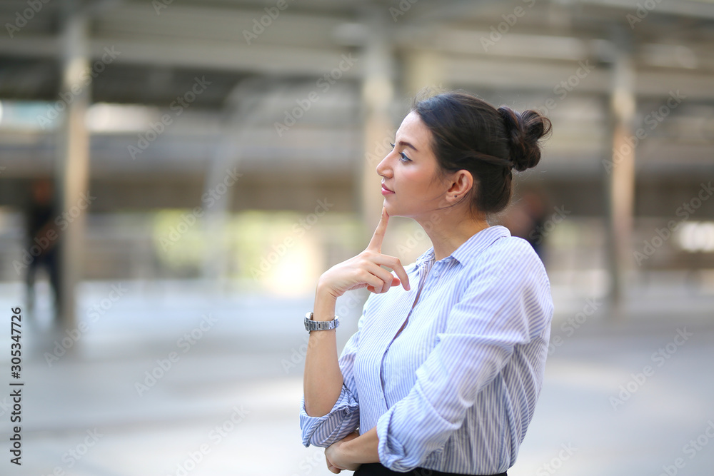 Portrait of smiling young beautiful business woman standing at outside.